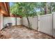 Cozy outdoor patio area surrounded by a privacy fence and mature trees, providing a serene setting for relaxation at 2078 Sunset Point Rd # 83, Clearwater, FL 33765