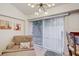 Cozy sitting area with vertical blinds and a view to the outside at 2078 Sunset Point Rd # 83, Clearwater, FL 33765
