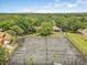Overhead view of community tennis courts surrounded by mature trees, offering a scenic and active lifestyle at 2078 Sunset Point Rd # 83, Clearwater, FL 33765