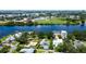 A picturesque aerial view of waterfront homes nestled along a tranquil river with a cityscape in the background at 2205 N Riverside Dr, Tampa, FL 33602