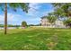 Lush green lawn and waterfront views enhance the property's charm, complemented by a classic white picket fence at 2205 N Riverside Dr, Tampa, FL 33602