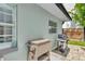 Exterior shot of a patio with a grill and ice cooler in a landscaped backyard with a privacy fence at 2205 N Riverside Dr, Tampa, FL 33602