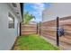 A lovely backyard area has green grass and wood fence that offers privacy at 2205 N Riverside Dr, Tampa, FL 33602