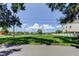 Waterfront lot featuring a lush grassy yard with mature trees and tranquil water views at 2205 N Riverside Dr, Tampa, FL 33602