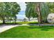 Expansive green lawn with mature trees offering shade and leading to a private dock on the waterfront at 2205 N Riverside Dr, Tampa, FL 33602