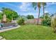 Expansive backyard with lush green grass, mature landscaping, and a privacy fence, perfect for outdoor enjoyment at 2205 N Riverside Dr, Tampa, FL 33602