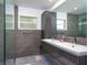 Bathroom with stylish double vanity, tiled walls, walk-in shower and modern finishes at 2205 N Riverside Dr, Tampa, FL 33602
