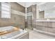 Modern bathroom with soaking tub, tiled shower, window, and double vanity at 2205 N Riverside Dr, Tampa, FL 33602