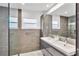 Modern bathroom featuring a double sink vanity, window and a glass shower at 2205 N Riverside Dr, Tampa, FL 33602