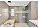This updated bathroom features a glass enclosed shower, soaking tub and neutral tile at 2205 N Riverside Dr, Tampa, FL 33602