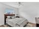 This charming bedroom features hardwood floors, a ceiling fan, and a window providing natural light at 2205 N Riverside Dr, Tampa, FL 33602