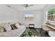 Cozy bedroom with a bed, small desk, and a window that lets in natural light at 2205 N Riverside Dr, Tampa, FL 33602