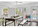 Modern dining room with a gray table, bench seating, and view of pool through window at 2205 N Riverside Dr, Tampa, FL 33602