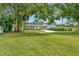 Well-maintained single-story home featuring a gray exterior and lush green front lawn at 2205 N Riverside Dr, Tampa, FL 33602