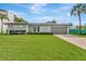 Charming home with well-maintained lawn, attached garage, and updated facade at 2205 N Riverside Dr, Tampa, FL 33602