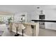 Bright, remodeled kitchen with stainless appliances, breakfast bar, granite countertops, and modern white cabinetry at 2205 N Riverside Dr, Tampa, FL 33602