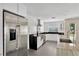 Modern kitchen with stainless steel appliances, white cabinets, granite countertops and gray tiled floor at 2205 N Riverside Dr, Tampa, FL 33602