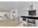 Bright, remodeled kitchen with stainless appliances, large island, granite countertops, and modern white cabinetry at 2205 N Riverside Dr, Tampa, FL 33602