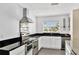 Kitchen featuring stainless steel appliances, granite countertops, white cabinets and gray tiled floors at 2205 N Riverside Dr, Tampa, FL 33602