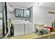 Functional laundry room with modern appliances, overhead storage, and a utility sink at 2205 N Riverside Dr, Tampa, FL 33602