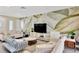 Living room displaying modern sofas, a decorative leaf wall, and bright, natural light at 2205 N Riverside Dr, Tampa, FL 33602