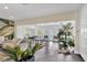 Bright, open-concept living room with modern furnishings and views to the outdoor pool area at 2205 N Riverside Dr, Tampa, FL 33602