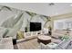 Cozy living room featuring leaf-themed wallpaper, contemporary furnishings and a bright and airy atmosphere at 2205 N Riverside Dr, Tampa, FL 33602