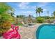Relaxing backyard pool area with pavers, lounge chairs, shade umbrellas and fun flamingo floaties under sunny skies at 2205 N Riverside Dr, Tampa, FL 33602