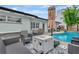Backyard pool area with comfortable seating, a modern fire pit, and a pristine pool at 2205 N Riverside Dr, Tampa, FL 33602