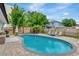Backyard oasis featuring a sparkling pool, paver patio, privacy fence, tropical landscaping, and outdoor lounge area at 2205 N Riverside Dr, Tampa, FL 33602
