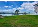 A scenic yard with a waterfront view featuring a dock and white picket fence at 2205 N Riverside Dr, Tampa, FL 33602
