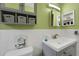 Bathroom showcasing a vanity with a gray cabinet, modern faucet, and decorative storage at 2256 Philippine Dr # 24, Clearwater, FL 33763