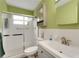 Bright bathroom featuring a shower with glass doors and a sink with a modern vanity at 2256 Philippine Dr # 24, Clearwater, FL 33763