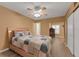Comfortable bedroom with a ceiling fan, light hardwood floors, and natural light at 2256 Philippine Dr # 24, Clearwater, FL 33763