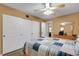 Comfortable bedroom featuring a ceiling fan, wood-look floors, and double closets at 2256 Philippine Dr # 24, Clearwater, FL 33763