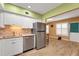 Bright kitchen featuring stainless steel appliances and white cabinets with tile backsplash at 2256 Philippine Dr # 24, Clearwater, FL 33763