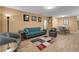 Bright, inviting living area with wood-look floors, stylish furnishings, and access to dining space at 2256 Philippine Dr # 24, Clearwater, FL 33763