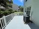 Cozy outdoor patio area with a white picket fence and an air conditioning unit outside the backdoor at 2256 Philippine Dr # 24, Clearwater, FL 33763