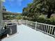 Outdoor patio with a white railing, seating, and an air conditioning unit at 2256 Philippine Dr # 24, Clearwater, FL 33763