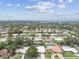 Stunning aerial view of a neighborhood with mature trees, lush landscaping, and nearby waterways at 2418 Cardwell Way, Sarasota, FL 34231