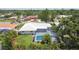 Aerial view of a home featuring a screened-in pool and lush landscaping in a residential neighborhood at 2418 Cardwell Way, Sarasota, FL 34231