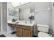 Comfortable bathroom features a white vanity with wood cabinets and tiled floors at 2418 Cardwell Way, Sarasota, FL 34231