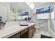 Bright bathroom features a vanity sink, a toilet, and a shower with glass doors at 2418 Cardwell Way, Sarasota, FL 34231