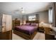 Bedroom features a bed with wood frame, matching dressers, neutral walls and soft lighting at 2418 Cardwell Way, Sarasota, FL 34231