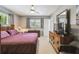 Bedroom features a bed with wood frame, matching dressers, neutral walls, soft lighting and a ceiling fan at 2418 Cardwell Way, Sarasota, FL 34231