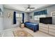 Cozy bedroom features neutral walls, ceiling fan and a nicely decorated window with dark blue curtains at 2418 Cardwell Way, Sarasota, FL 34231