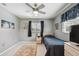 Comfortable bedroom features light grey walls, a ceiling fan, and an area rug on the floor at 2418 Cardwell Way, Sarasota, FL 34231