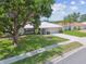 Charming single-story home featuring a well-manicured lawn and a two-car garage at 2418 Cardwell Way, Sarasota, FL 34231