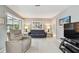 Serene living room with neutral tones, comfortable seating, and a large window for natural light at 2418 Cardwell Way, Sarasota, FL 34231