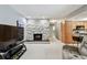 Spacious living room showcases a stone fireplace, neutral carpeting, and seamless transition to the kitchen at 2418 Cardwell Way, Sarasota, FL 34231